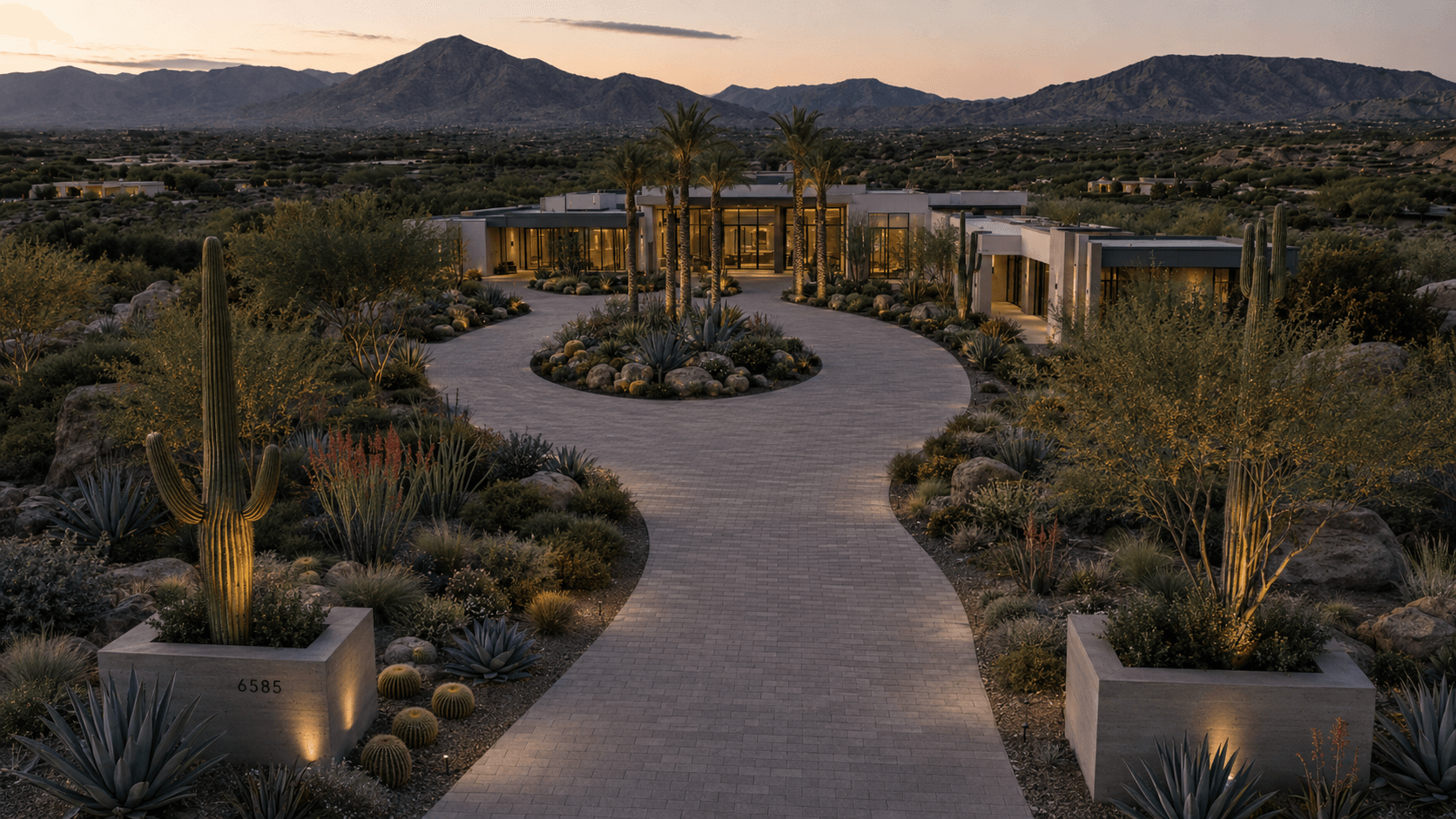 Luxury Arizona paver driveway and entry with travertine banding at dusk